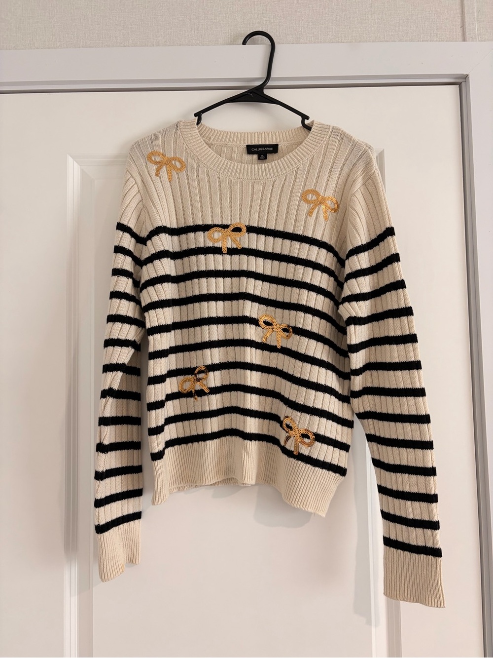 Cream & Black Striped Crewneck Sweater with Gold Bow Accents